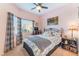 Comfortable bedroom with a ceiling fan and lots of natural light at 6061 Leaping Foal St, North Las Vegas, NV 89081