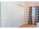 Bedroom closet and window with privacy blinds and curtains at 6061 Leaping Foal St, North Las Vegas, NV 89081