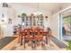Open dining room with a view to the backyard and a display cabinet at 6061 Leaping Foal St, North Las Vegas, NV 89081