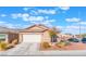 Lovely single-story home with a two-car garage, desert landscaping, tile roof, and a paved driveway at 6061 Leaping Foal St, North Las Vegas, NV 89081
