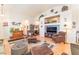 Spacious living room boasts vaulted ceilings, wood floors, plenty of natural light, and comfortable seating at 6061 Leaping Foal St, North Las Vegas, NV 89081
