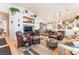 Open-concept living room with vaulted ceilings, wood floors, and comfortable seating at 6061 Leaping Foal St, North Las Vegas, NV 89081