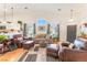 Inviting living room features high ceilings, a large window, comfortable seating, and wood floors at 6061 Leaping Foal St, North Las Vegas, NV 89081
