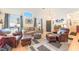 Bright living room with vaulted ceilings, wood floors, comfortable seating, and a large window at 6061 Leaping Foal St, North Las Vegas, NV 89081