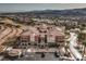 Multi-Gathering condo building with red tile roof, patios, and balconies nestled in desert landscape with mountain and lake views at 64 Strada Principale # 205, Henderson, NV 89011