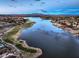 Beautiful aerial view of Lake Las Vegas featuring a golf course and homes along the water at 64 Strada Principale # 205, Henderson, NV 89011