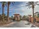 A community entry gate with well manicured grounds, trees and shrubbery on a clear day at 64 Strada Principale # 205, Henderson, NV 89011