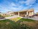 Landscaped backyard featuring a covered patio with a built-in grill, ideal for outdoor gatherings and relaxation at 6627 Bristle Canyon Ave, Las Vegas, NV 89110