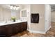 Spacious bathroom with double sinks, dark wood cabinetry, and stylish modern finishes at 6627 Bristle Canyon Ave, Las Vegas, NV 89110