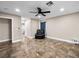 Comfortable bedroom with a ceiling fan, tile flooring, and a cozy reading chair at 6627 Bristle Canyon Ave, Las Vegas, NV 89110