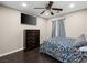 Cozy bedroom with a dark wood floor, featuring a decorative ceiling fan and a dresser at 6627 Bristle Canyon Ave, Las Vegas, NV 89110