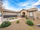Well-maintained home featuring desert landscaping with a seating bench and a covered entryway at 6627 Bristle Canyon Ave, Las Vegas, NV 89110