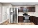 Modern kitchen appliances including a stainless steel refrigerator and a gas range at 6627 Bristle Canyon Ave, Las Vegas, NV 89110