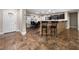 Open kitchen and dining area with tile floors and modern appliances at 6627 Bristle Canyon Ave, Las Vegas, NV 89110