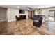 Open living area featuring tile flooring, a ceiling fan, and sliding glass doors to the backyard at 6627 Bristle Canyon Ave, Las Vegas, NV 89110