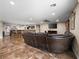 Expansive living space with open bar and kitchen view, highlighted by stylish tile flooring at 6627 Bristle Canyon Ave, Las Vegas, NV 89110