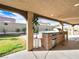 A covered outdoor kitchen and spacious backyard offers the ideal entertaining space at 6627 Bristle Canyon Ave, Las Vegas, NV 89110