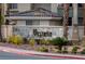 Elegant 'Vistaña' sign made of stone, complemented by palm trees and desert landscaping at 7115 S Durango Dr # 308, Las Vegas, NV 89113
