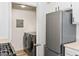 Adjacent laundry room with modern washer and dryer, next to the kitchen at 7115 S Durango Dr # 308, Las Vegas, NV 89113
