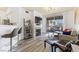 Open living space with a fireplace, balcony, and bar seating area at 7115 S Durango Dr # 308, Las Vegas, NV 89113