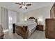 Bedroom boasts a decorative ceiling fan, dark wood furnishings, and a neutral color scheme at 7115 S Durango Dr # 313, Las Vegas, NV 89113