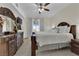 Bedroom boasts dark wood furnishings, tile floors, a ceiling fan, and sliding door to balcony at 7115 S Durango Dr # 313, Las Vegas, NV 89113