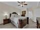 Bedroom features a decorative ceiling fan, dark wood furnishings, and tiled floors at 7115 S Durango Dr # 313, Las Vegas, NV 89113
