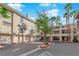 Well-maintained building exterior with garage parking, lush landscaping and red trimmed flower beds at 7115 S Durango Dr # 313, Las Vegas, NV 89113