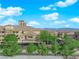 Well-maintained building exterior featuring lush trees, covered parking and community amenities at 7115 S Durango Dr # 313, Las Vegas, NV 89113