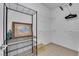Walk-in closet features ventilated shelving units, an iron, and framed artwork at 7115 S Durango Dr # 313, Las Vegas, NV 89113