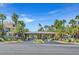 Welcoming community entrance featuring lush landscaping, palm trees and covered entry at 7115 S Durango Dr # 313, Las Vegas, NV 89113