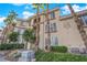 Attractive building exterior with private balconies, lush landscaping and exterior unit numbers at 7115 S Durango Dr # 313, Las Vegas, NV 89113