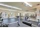 Bright and airy gym featuring weight machines, cardio equipment, and a mirrored wall at 7115 S Durango Dr # 313, Las Vegas, NV 89113