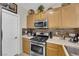 Well-equipped kitchen featuring stainless steel appliances and bright countertops at 7115 S Durango Dr # 313, Las Vegas, NV 89113