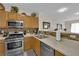 Well-lit kitchen featuring stainless steel appliances, and a breakfast bar, perfect for casual dining at 7115 S Durango Dr # 313, Las Vegas, NV 89113