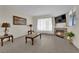 Comfortable living room featuring a fireplace, neutral walls and large windows for ample light at 7115 S Durango Dr # 313, Las Vegas, NV 89113