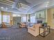 Community lounge features a decorative ceiling, neutral colored couches, a fireplace and carpet at 7115 S Durango Dr # 313, Las Vegas, NV 89113