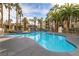 Resort-style pool surrounded by palm trees and lounge chairs at 7115 S Durango Dr # 313, Las Vegas, NV 89113