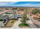 An aerial view shows the property's landscaping, private pool, putting green, and beach volleyball court at 723 Spanish Dr, Las Vegas, NV 89110