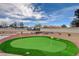 Backyard with a putting green, fire pit, and desert landscaping makes this property an entertainer's dream at 723 Spanish Dr, Las Vegas, NV 89110