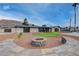 Backyard with a putting green, fire pit, and desert landscaping makes this property an entertainer's dream at 723 Spanish Dr, Las Vegas, NV 89110