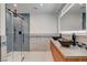 Elegant bathroom with dual vessel sinks, walk-in shower, and modern vanity with ample lighting at 723 Spanish Dr, Las Vegas, NV 89110