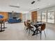 Open concept dining room with modern lighting, access to living area and large windows at 723 Spanish Dr, Las Vegas, NV 89110
