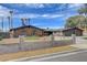 Attractive exterior view of single-story home with landscaped front yard, rock, and low wall at 723 Spanish Dr, Las Vegas, NV 89110