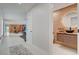 Bright hallway leading to an open-concept living space, with a half bath featuring a wooden vanity at 723 Spanish Dr, Las Vegas, NV 89110