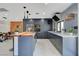 Modern kitchen with wood island, blue cabinets, and open to dining and living space at 723 Spanish Dr, Las Vegas, NV 89110