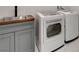 Well-equipped laundry area featuring a sink, gray cabinetry, and modern washer and dryer units at 723 Spanish Dr, Las Vegas, NV 89110