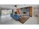 Bright living room with fireplace, wood wall, modern tile floor and outdoor access at 723 Spanish Dr, Las Vegas, NV 89110