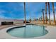 Backyard swimming pool surrounded by palm trees with a clear blue sky in the background at 723 Spanish Dr, Las Vegas, NV 89110