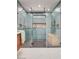 Luxurious glass shower enclosure with dual shower heads, tiled accent wall, and convenient built-in shelving at 723 Spanish Dr, Las Vegas, NV 89110